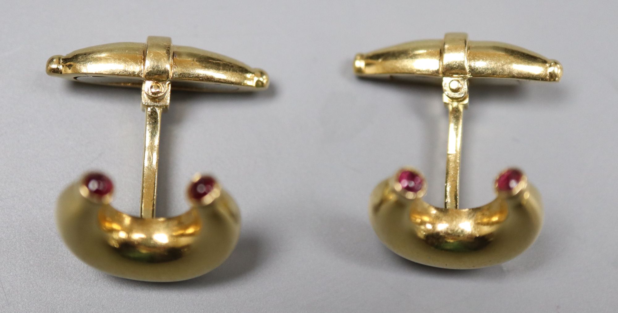 A pair of modern 18ct gold and ruby set horseshoe shaped cufflinks by Mappin & Webb